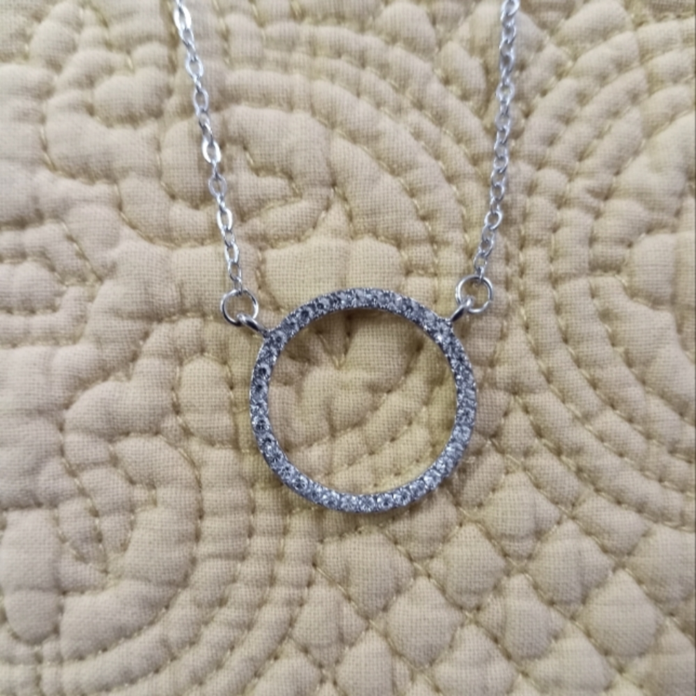 Brand New. No tags circle halo necklace in silver tone.